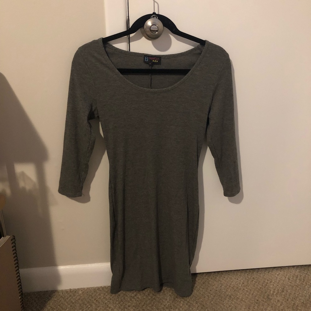 tight, dark gray bodycon dress. above finger tip